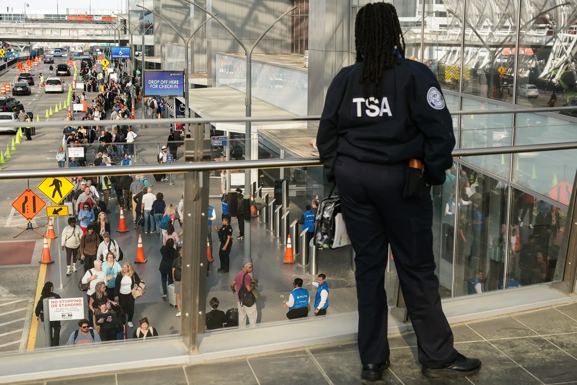 A TSA agent looks out at travelers waiting in line at a TSA checkpoint at Hartsfield-Jackson Atlanta International Airport&nbsp;in Atlanta, Georgia.