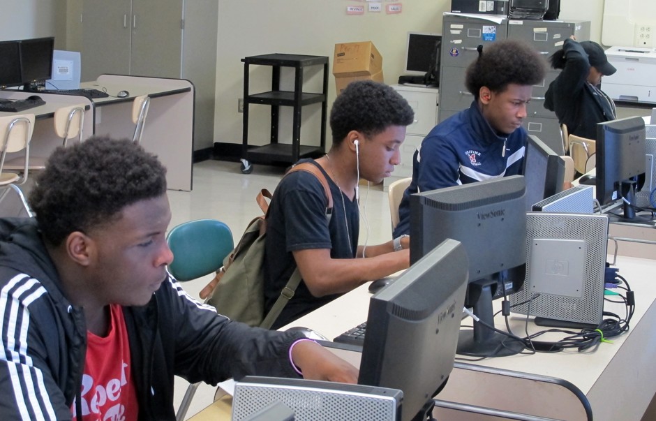 Students work at computers inside Bennett High School in Buffalo, N.Y., one of five troubled high schools being redesigned with a focus on specialty programming, such as computer science or solar energy.
