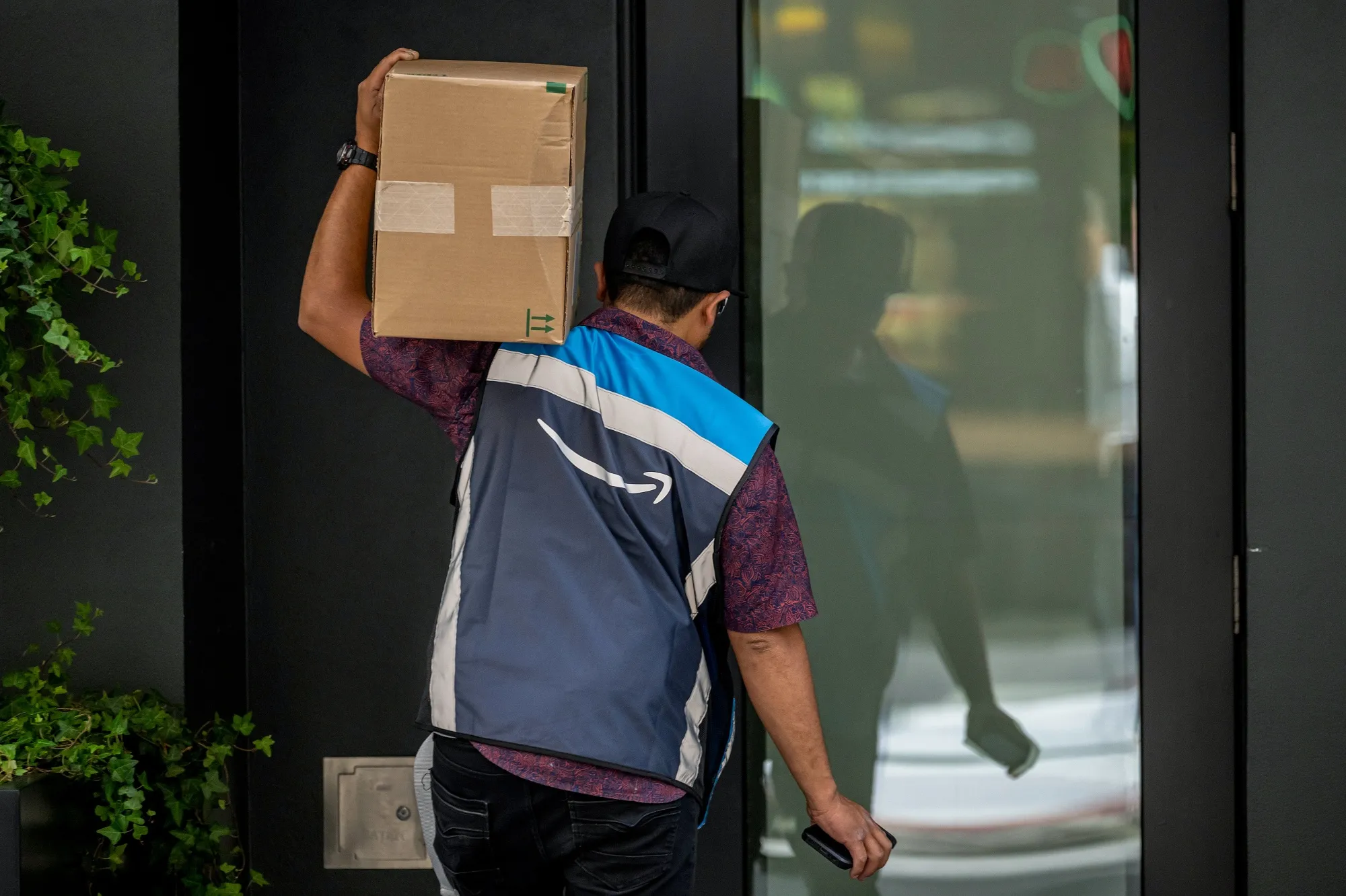 An Amazon worker delivers a package in San Francisco.