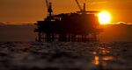 An offshore oil and gas platform stands at sunset in the Beta Field off the coast of Long Beach, California, U.S.