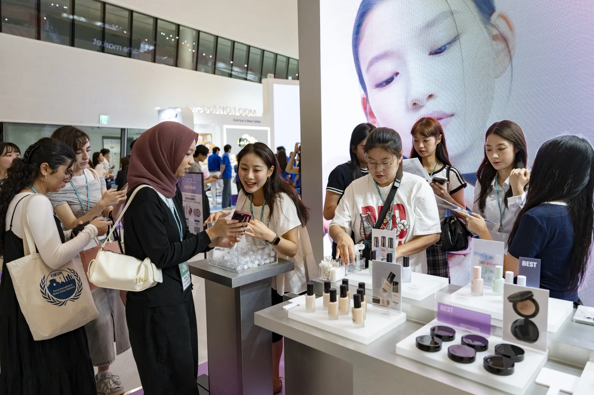 Visitors explore exhibition booths and beauty-related products in Seoul.
