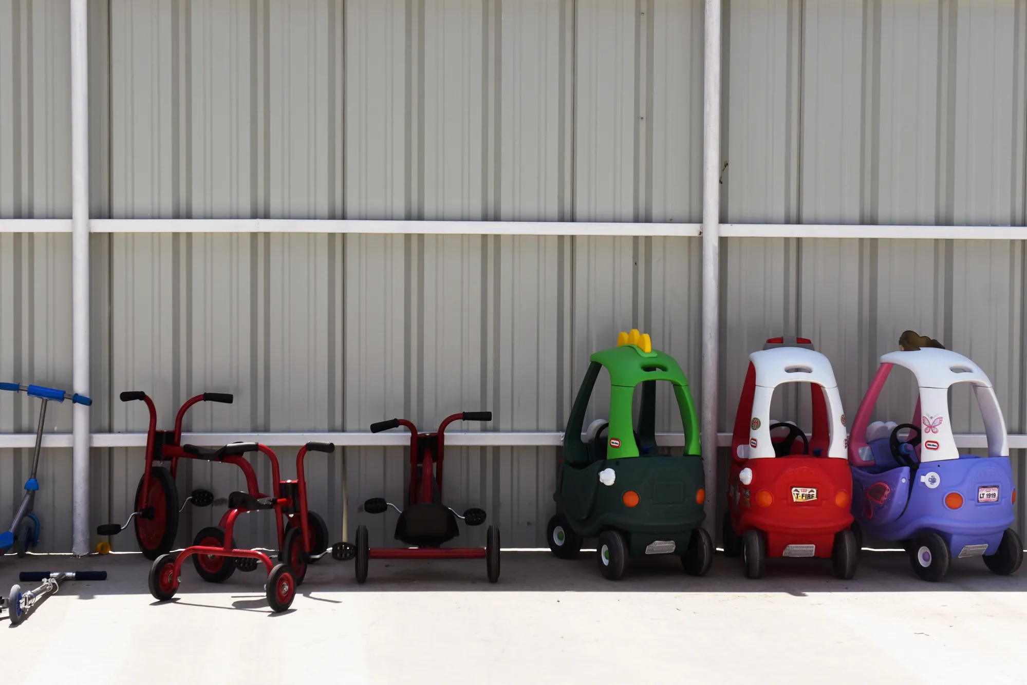 Tricycles and riding toys outside a daycare center in Monahans, Texas.