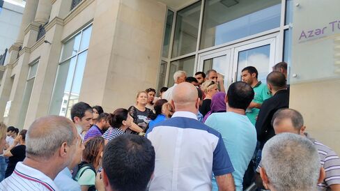 People queue outside an Azer Turk bank branch in Baku on Sept. 5.
