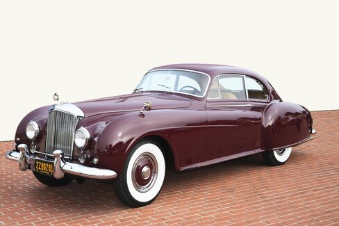 The graceful 1954 Bentley R-Type Continental features an alloy body and a powerful inline 6-cylinder engine. This was the last car Bentley made with a stick-shift gearbox - and it came as an option.