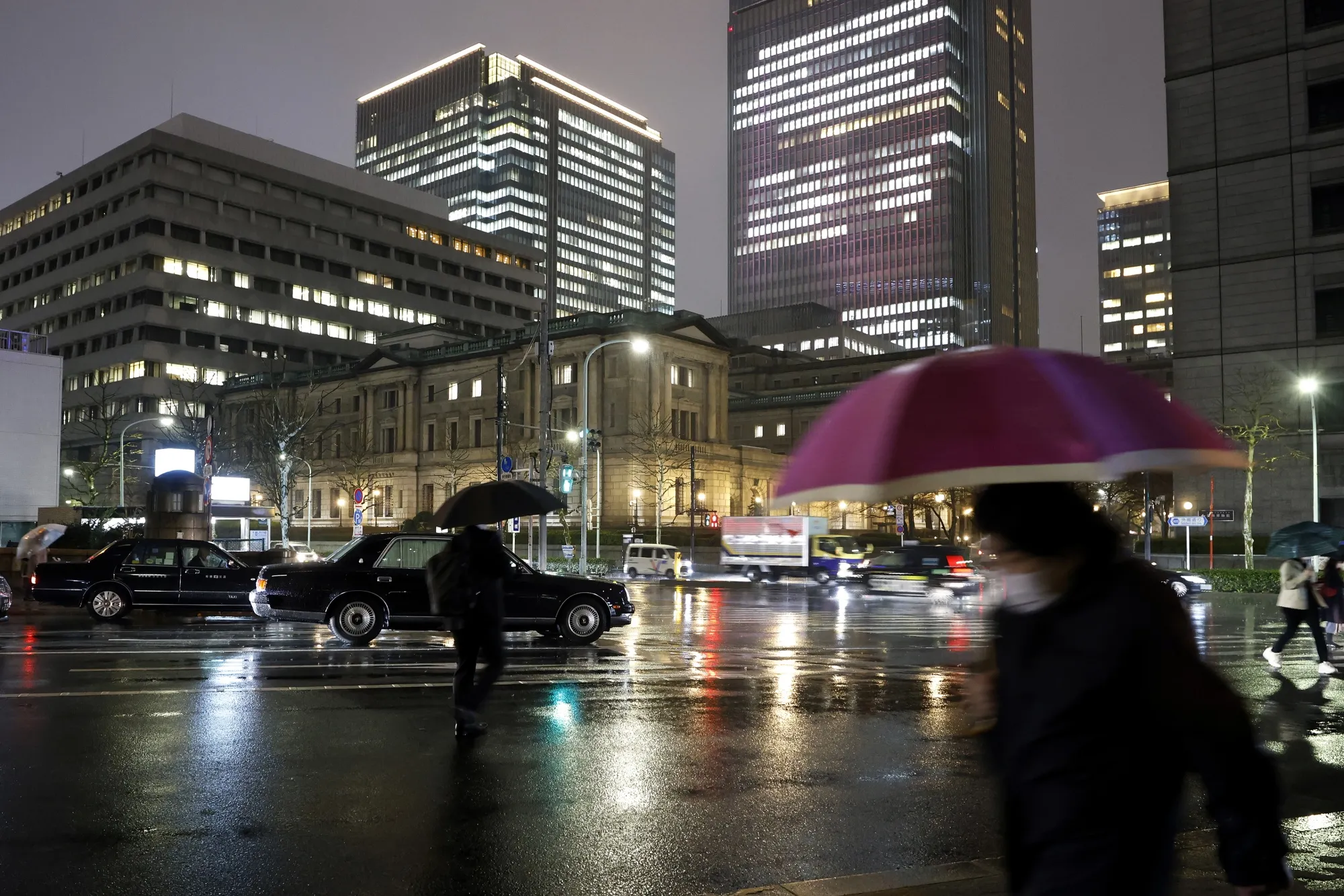 Pedestrians and traffic pass the&nbsp;Bank of Japan&nbsp;headquarters in Tokyo, Japan.