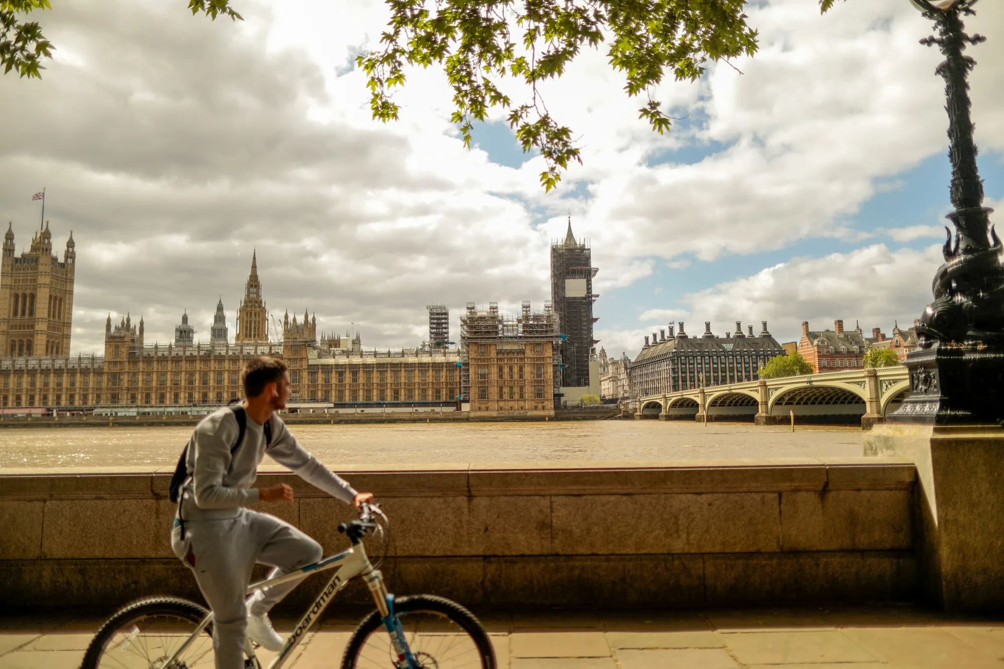 A cyclist travels along the Thames Path in view of the Houses of Parliament in London, on May 11.