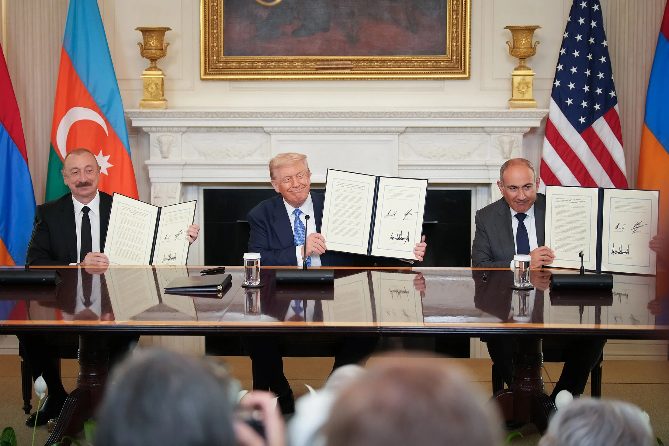 Ilham Aliyev, Azerbaijan's president, from left, US President Donald Trump, and Nikol Pashinyan, Armenia's prime minister,&nbsp;hold up an agreement signed during a ceremony at the&nbsp; White House on Aug.&nbsp;8.