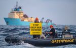 A Greenpeace International activist in April 2021 displays a banner in front of the Maersk Launcher, a ship chartered by DeepGreen, one of the companies spearheading the drive to mine the barely understood deep sea ecosystem.