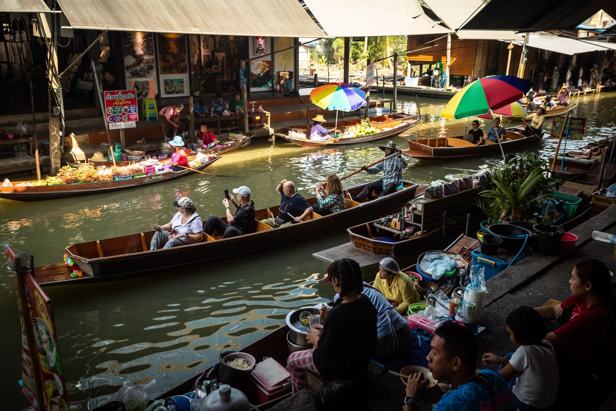 Tourists at a floating market in Damnoen Saduak, Thailand.