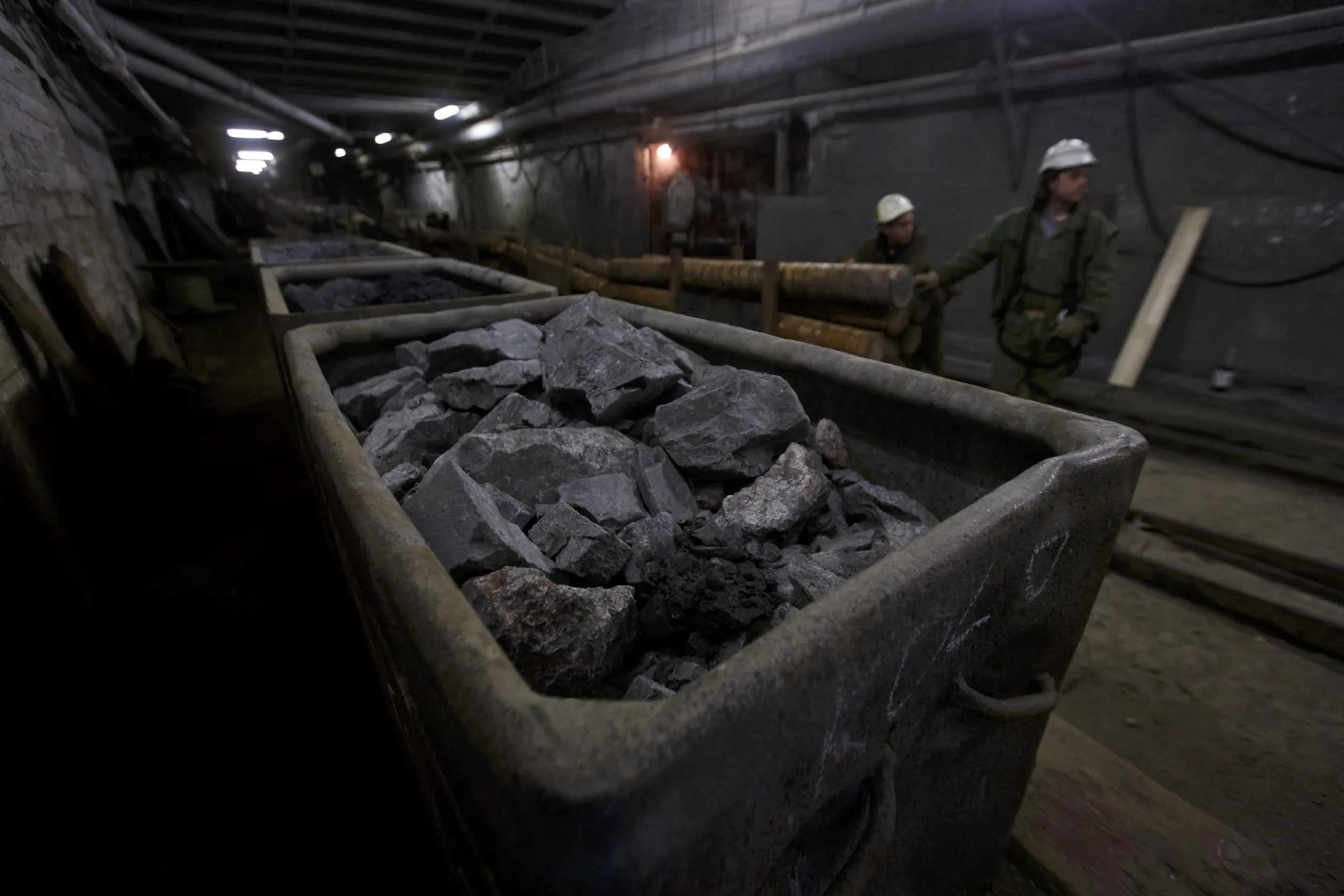 Rail trucks loaded with rocks containing uranium ore.