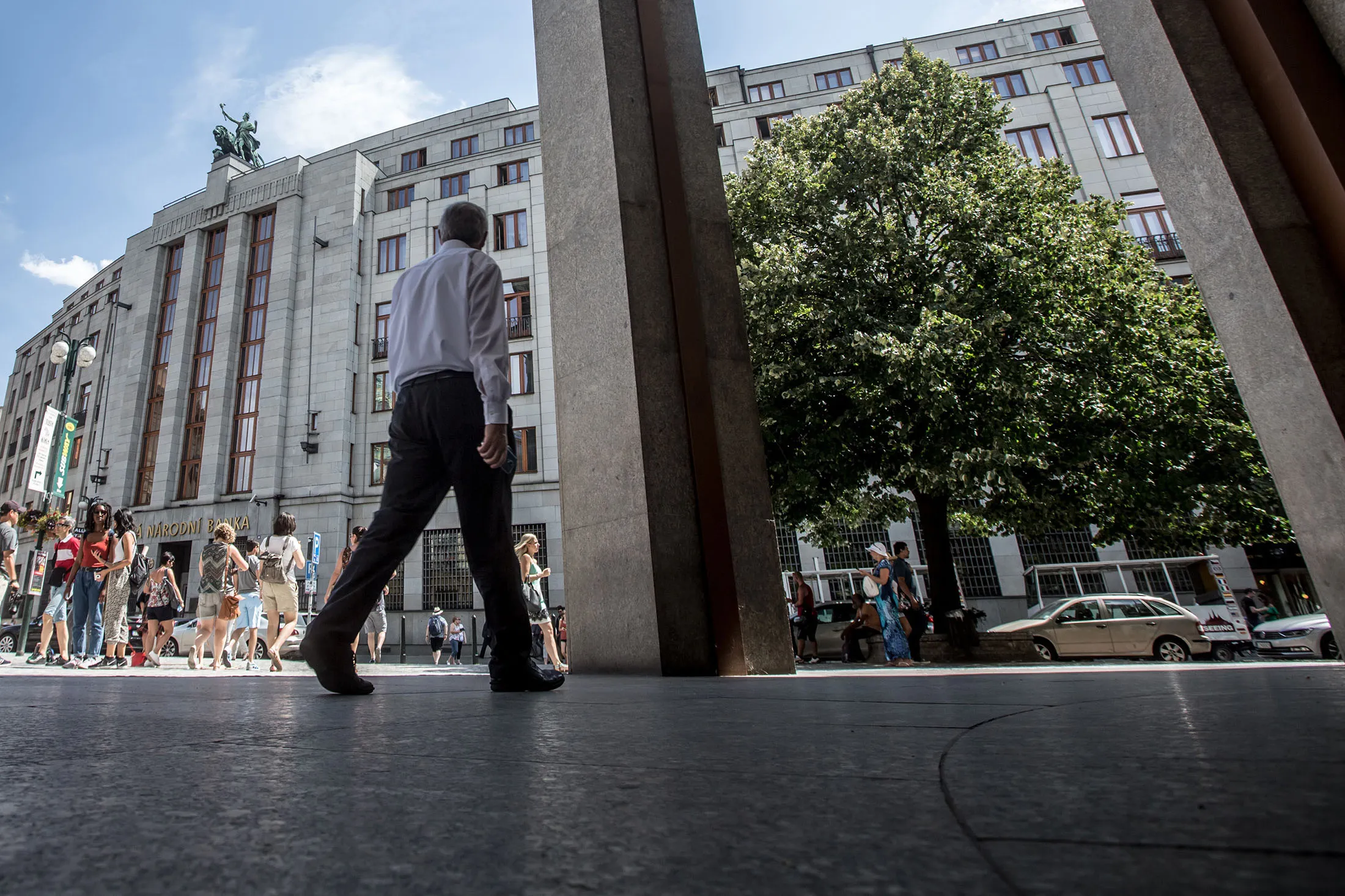 A pedestrian walks past the headquarters of the Czech central bank, also known as Ceska Narodni Banka (CNB), in Prague, Czech Republic, on Thursday, Aug. 4. 2016. The Czech central bank, in a meeting led by its first new governor in six years, kept interest rates at what it calls “technical zero” and maintained a commitment to cap appreciation in the koruna.
