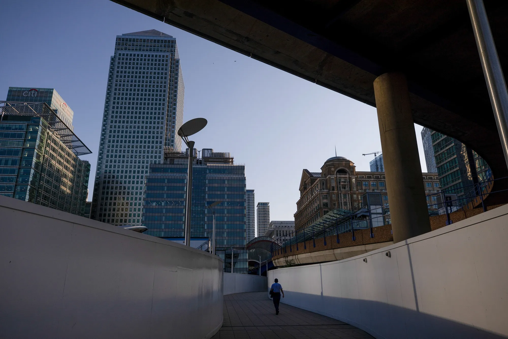 A pedestrian walks through the Canary Wharf business, financial and shopping district of London, on Sept. 14.