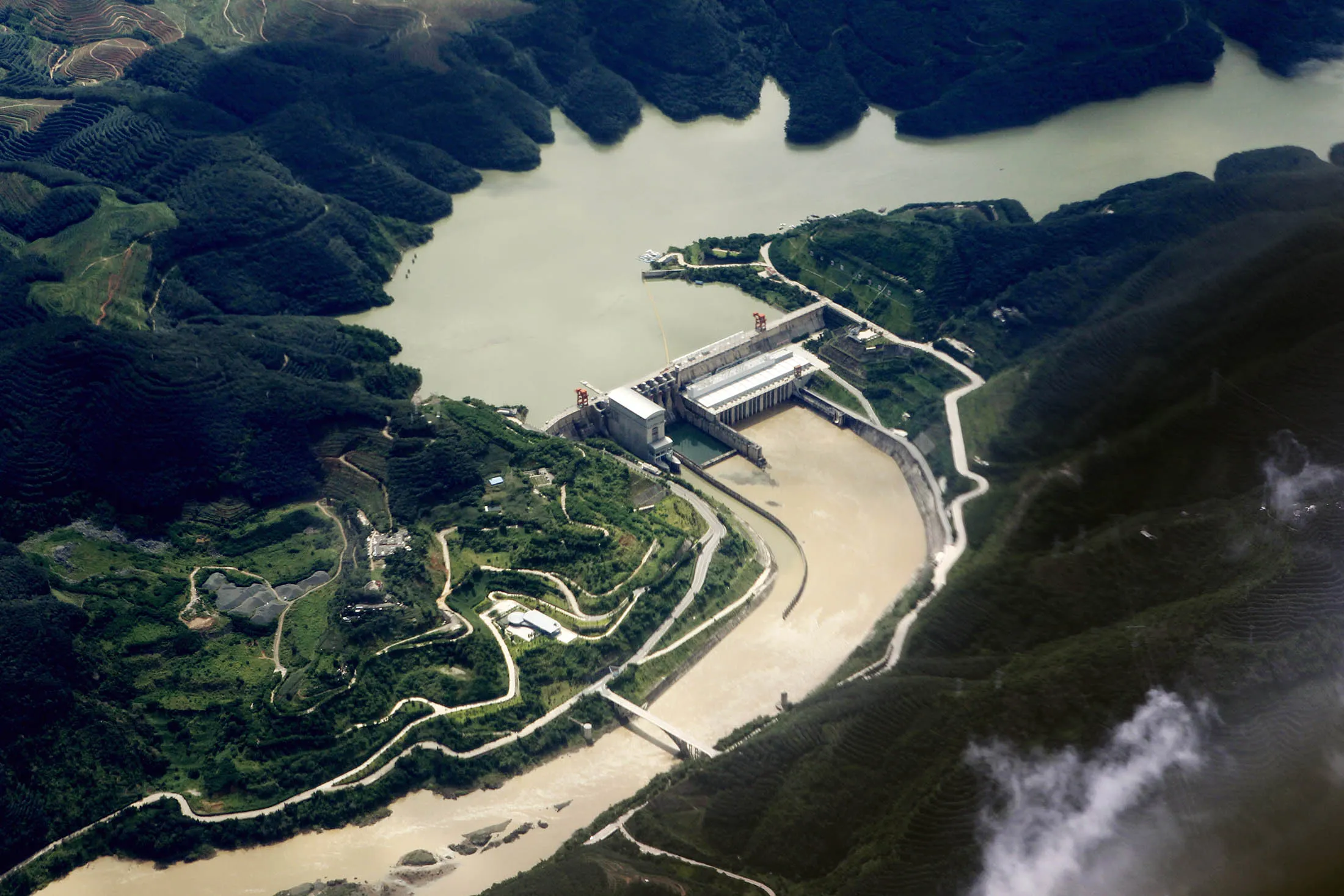--FILE--An aerial view of the dam at the Jinghong Hydropower Station on the Lancang River, the Chinese part of the Mekong River, in Jinghong city, Xishuangbanna Dai Autonomous Prefecture, southwest China's Yunnan province, 9 August 2013. China will release water from a dam in its southwestern province of Yunnan to help alleviate a drought in parts of Southeast Asia, including Vietnam, China's Foreign Ministry said on Tuesday (15 March 2016). The water will be released until April 10 from the Jinghong dam, ministry spokesman Lu Kang told a daily news briefing. It will benefit Cambodia, Laos, Myanmar, Thailand and Vietnam, Lu added. China 'hopes it can be of help in alleviating the drought downstream', he said. The Jinghong Dam is a gravity dam composed of roller-compacted concrete on the Lancang River, the Chinese part of the Mekong River, near Jinghong in Yunnan Province, China. The main purpose of the dam is hydroelectric power production and it has an associated 1,750 MW power station
