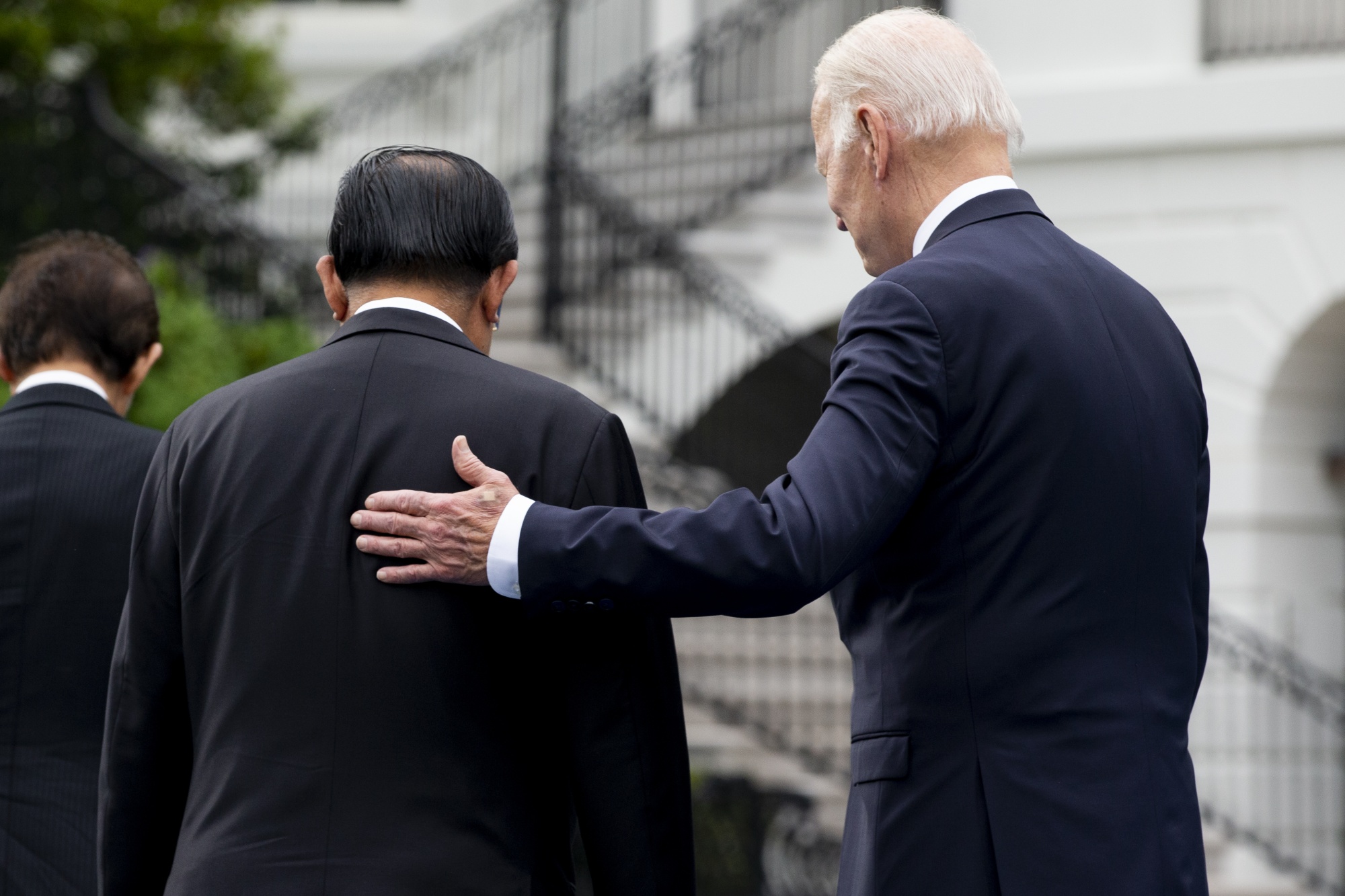 Joe Biden, right, walks with Hun Sen on the South Lawn of the White House on May 12.