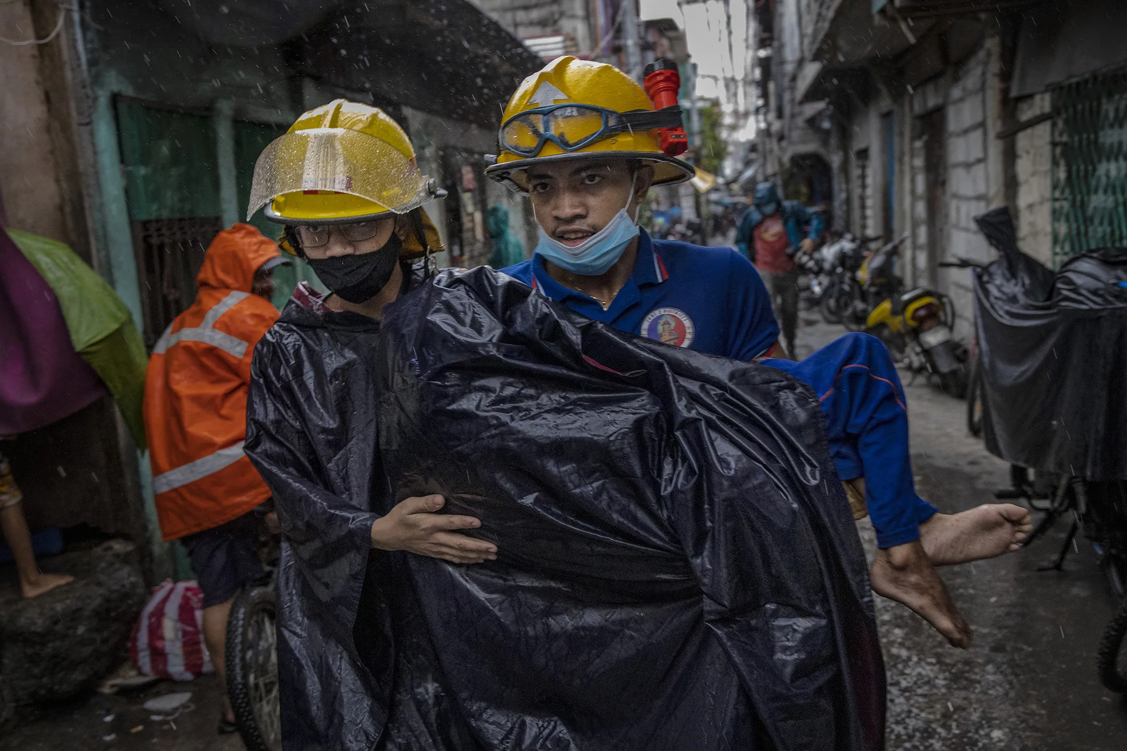 Rescue workers in Manila on Sunday. Dozens of areas, including Metro Manila, have been placed under storm alert.