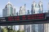 The key index of Shanghai and Shenzhen Stock Exchanges is displayed on a monitor hanging from a pedestrian overpass at Lujiazui on September 13, 2017 in Shanghai, China.