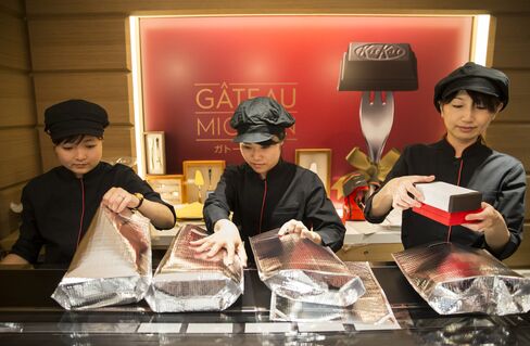 「キットカット ショコラトリー ガトーミニョン」の箱を包装する店員
