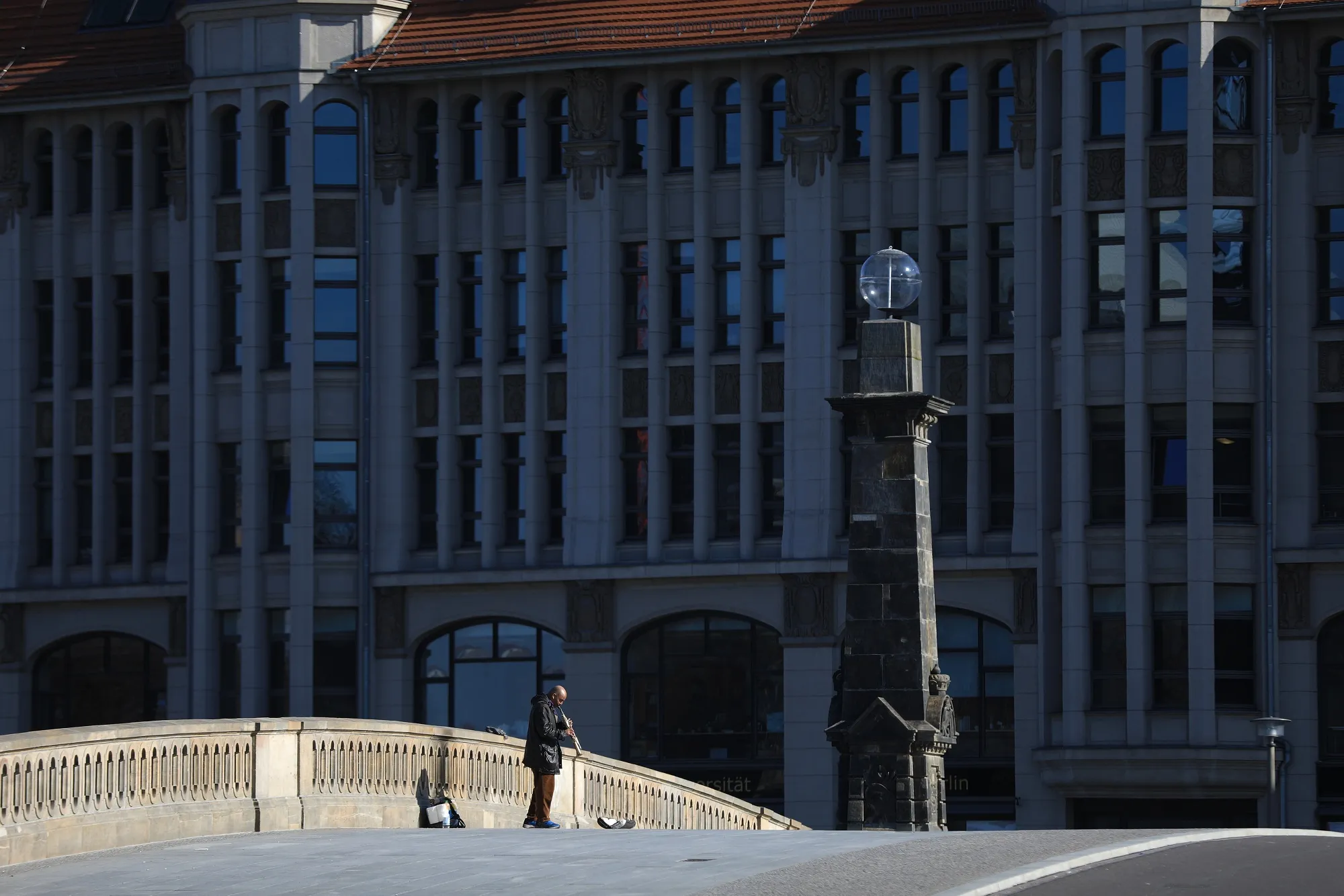 A busker plays a clarinet on a deserted bridge on March 16 with Berlin&nbsp;closes down to combat the spread of coronavirus.