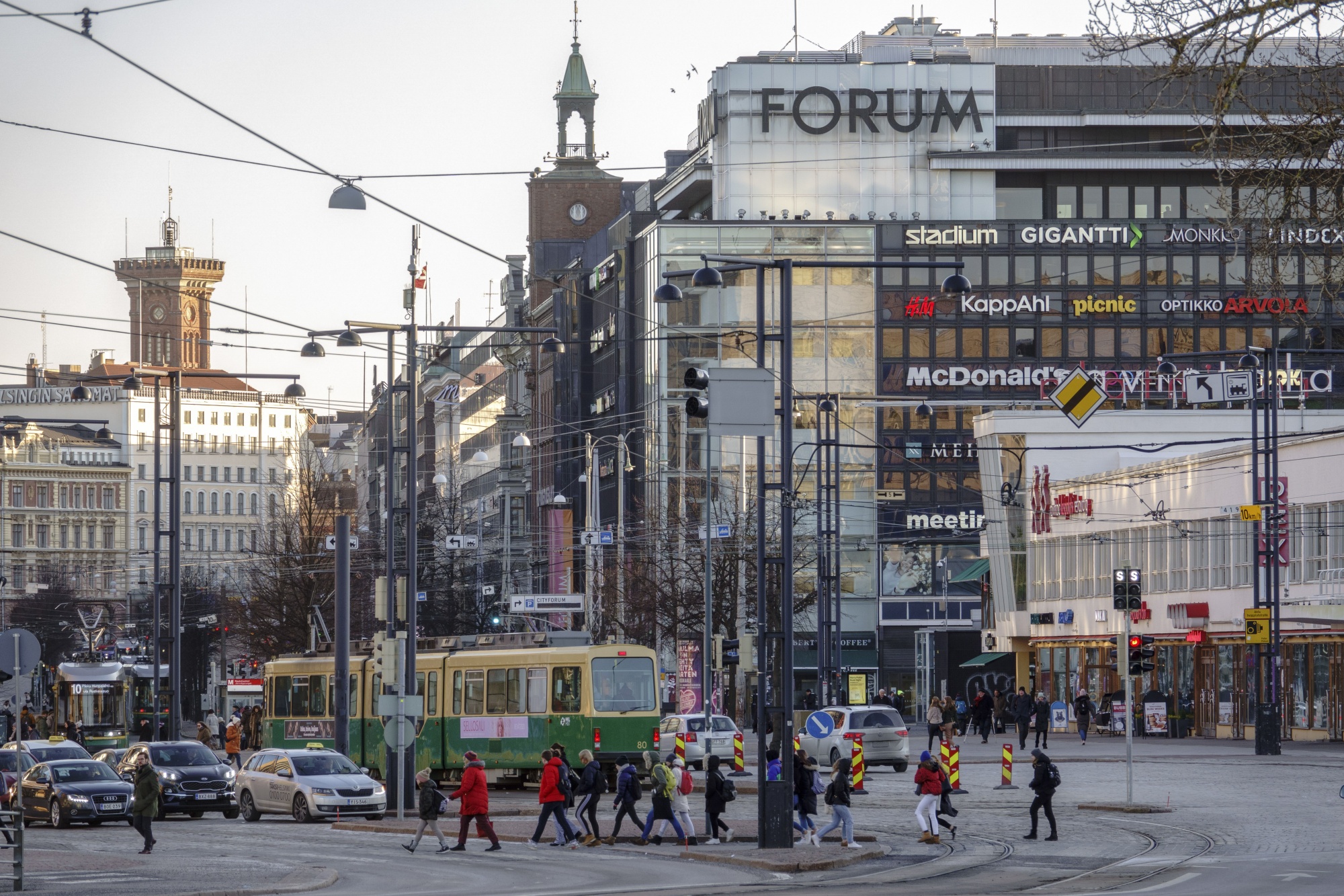 Pedestrians cross tramlines in near the Forum shopping center in Helsinki.