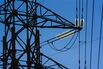 Electrical power lines hang from a transmission pylon