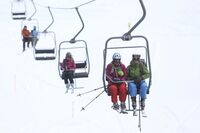 Skiers sit and travel on the Schatzalp chair lift as it moves up a mountain in the town of Davos, Switzerland, on Saturday, Jan. 19, 2013. Next week the business elite gather in the Swiss Alps for the 43rd annual meeting of the World Economic Forum in Davos, the five day event runs from Jan. 23-27.