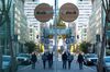 Pedestrians wearing protective masks walk past Slack Technologies Inc. headquarters in San Francisco, California, U.S., on Wednesday, Dec. 2, 2020. Salesforce.com Inc. agreed to buy Slack Technologies Inc. for $27.7 billion in cash and stock, giving the corporate software giant a popular workplace-communications platform in one of the biggest technology deals of the year.