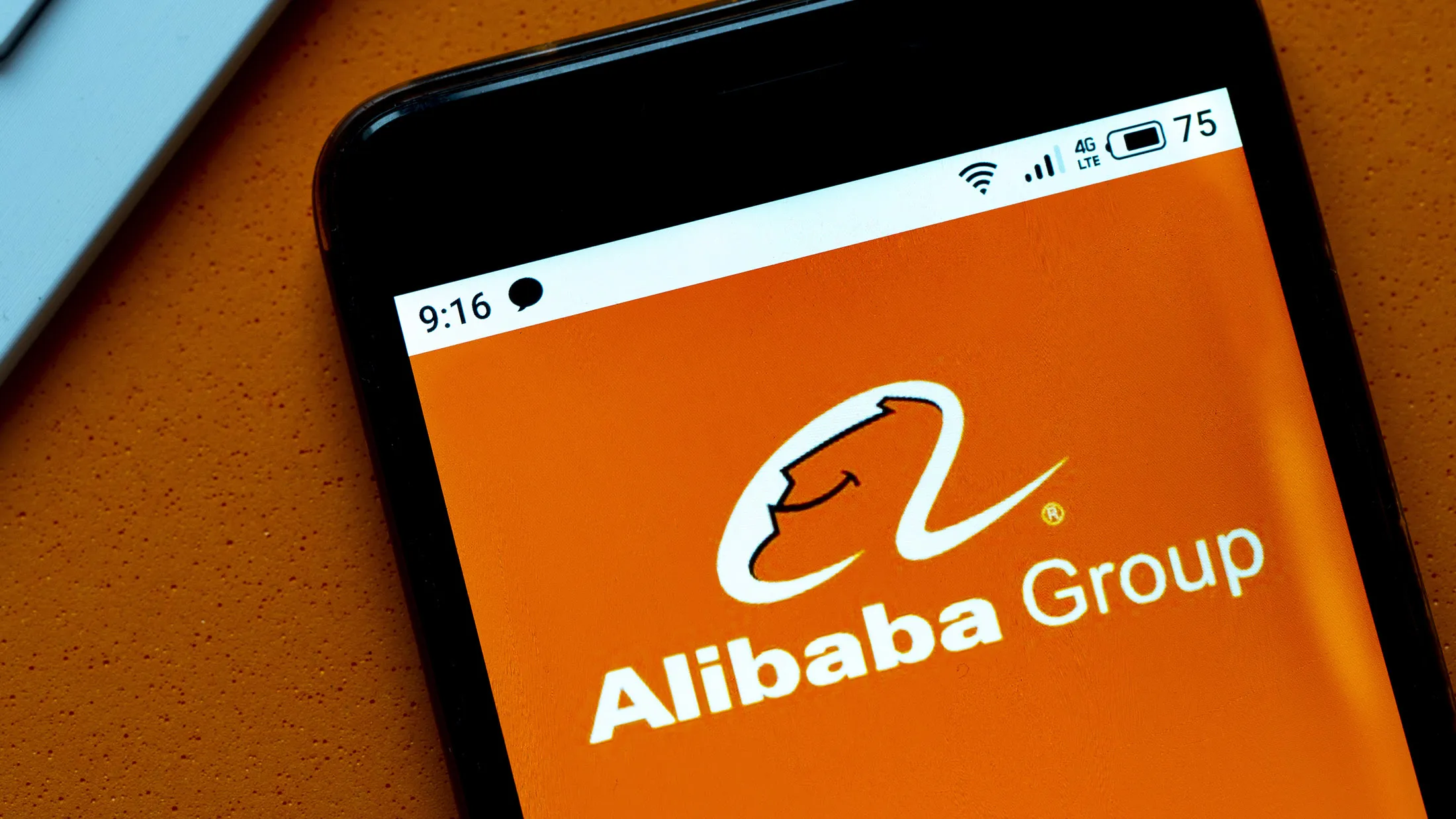 In this photo illustration an Alibaba logo seen displayed on