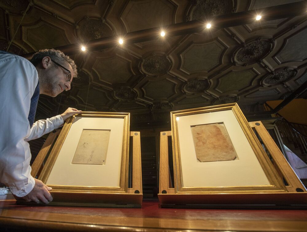 Martin Clayton, head of prints and drawings at the Royal Collection Trust, with a drawing (left) that has been recently confirmed as a portrait of Leonardo Da Vinci.