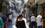 Pedestrians pass gift stores in the Monastiraki district of Athens, Greece, on Thursday, July 2, 2015.
