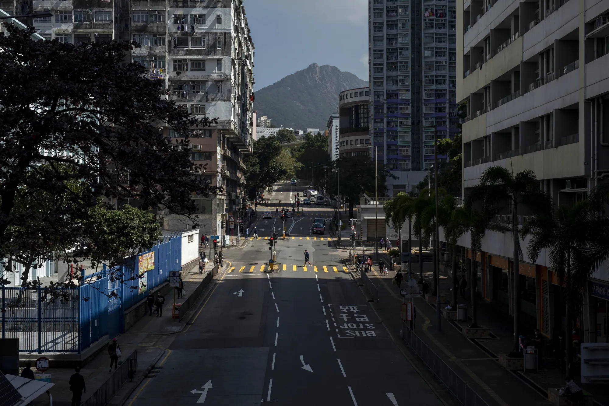 A pedestrian crosses a near empty road in Hong Kong, on March 1.