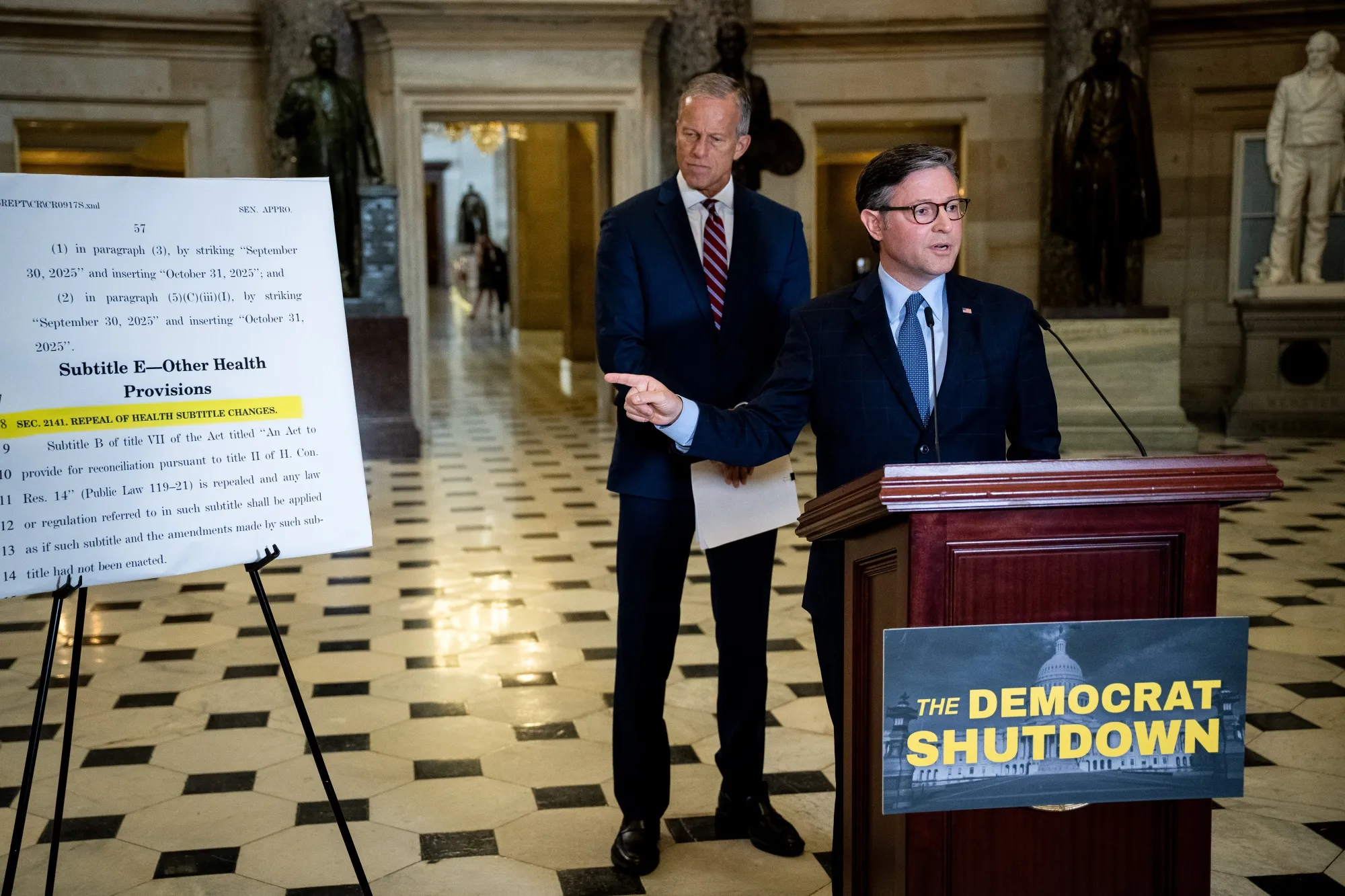 House Speaker Mike Johnson, right, speaks during a news conference in Statuary Hall at the US Capitol on Oct. 3.