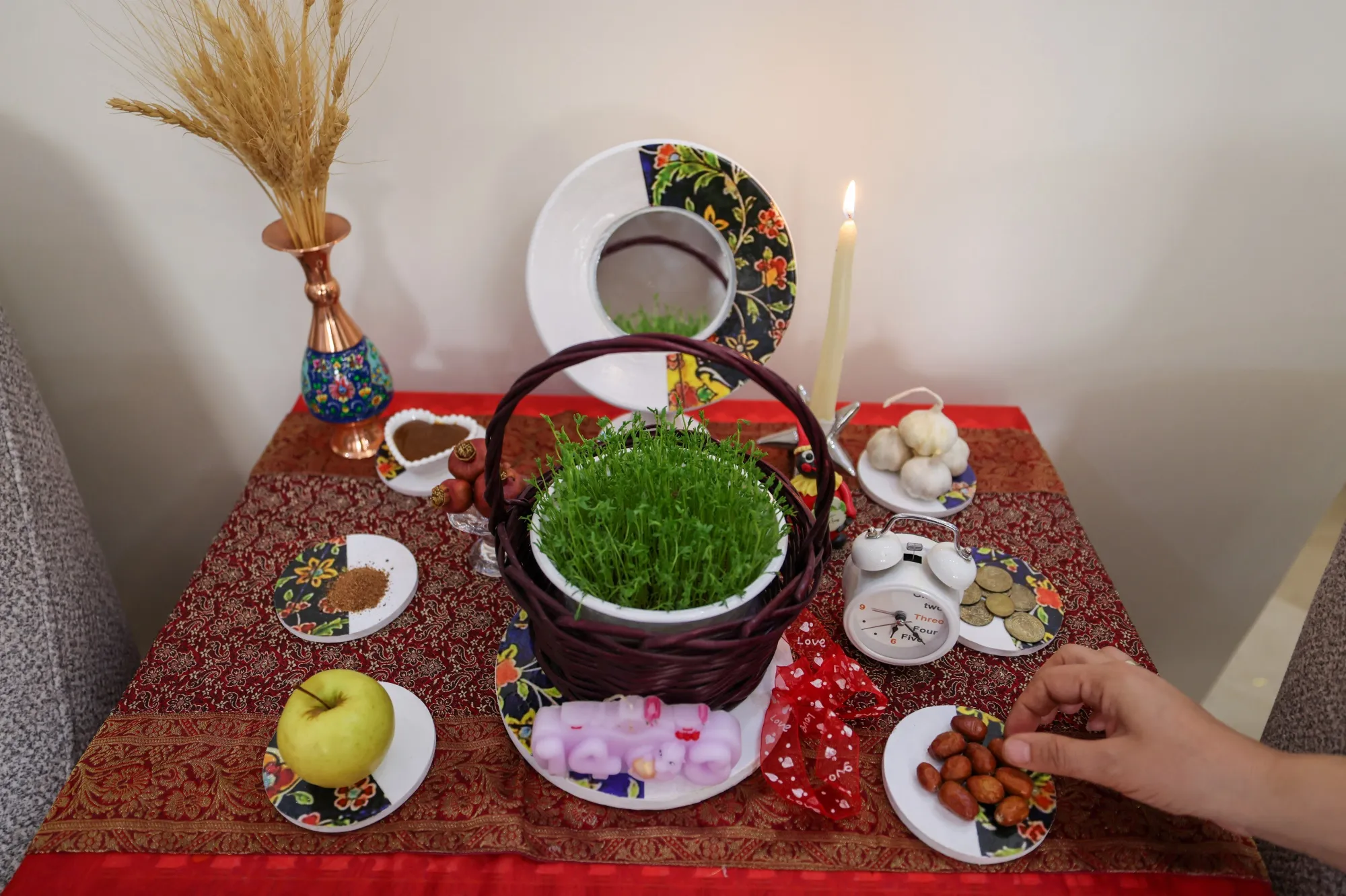 An Iranian decorates a table with “Haft Seen”&nbsp;in Tehran on March 17, 2024, in preparation for Nowruz, the Persian New Year.