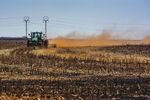 A tractor ploughs ground through a harvested corn field on a farm in Mpumalanga province, South Africa.