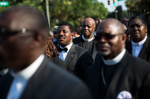 Clergy members wait to enter the funeral service for Sen. Clementa Pinckney, Friday, June 26, 2015, in Charleston, S.C. President Barack Obama will deliver the eulogy at Pinckney's funeral at a college arena near the Emanuel AME Church, the scene of last week's shooting.