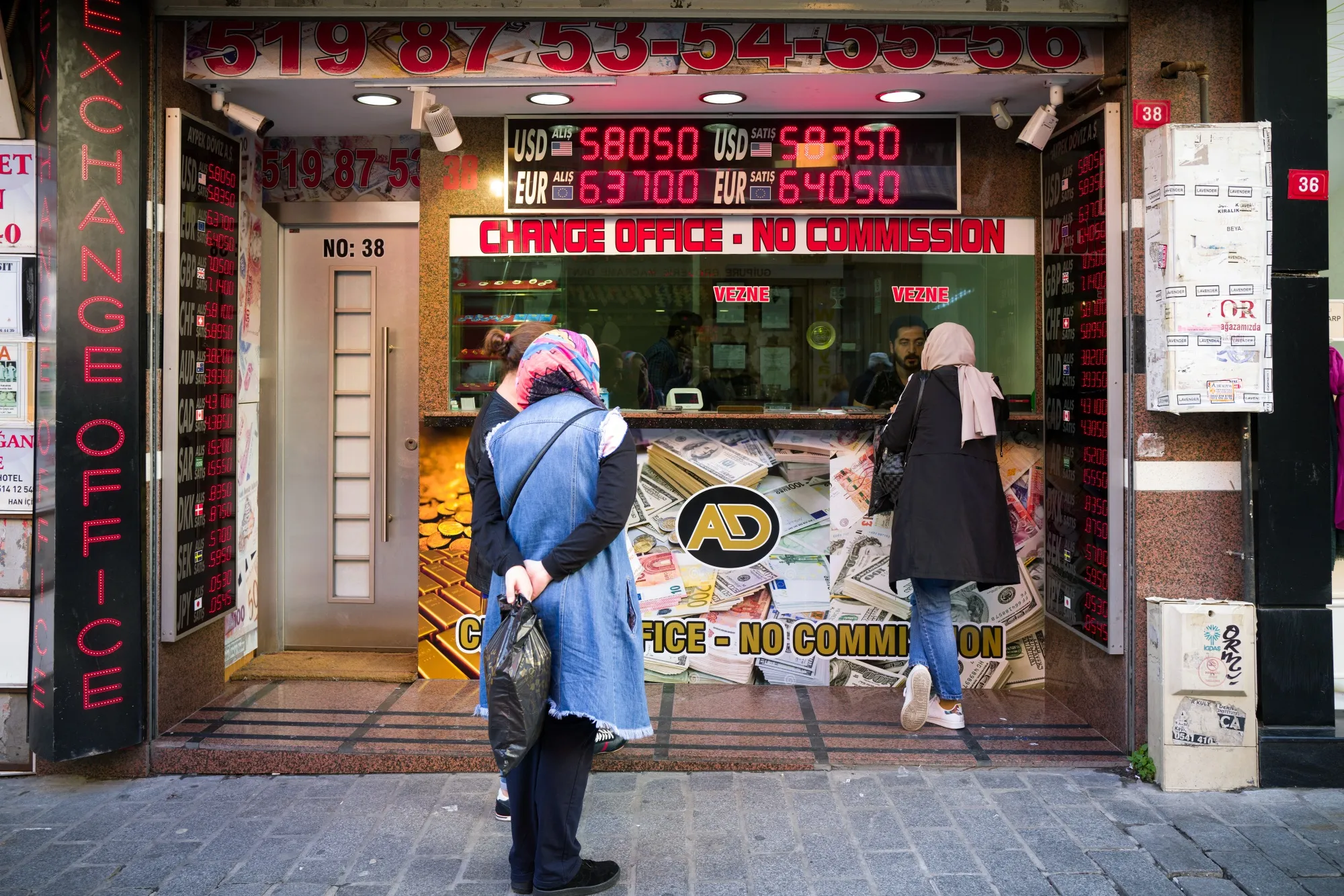 Pedestrians check rates displayed at a foreign exchange bureau in&nbsp;Istanbul.