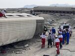 Rescuers work at the scene where a passenger train partially derailed near the desert city of Tabas in eastern Iran, on&nbsp;June 8.&nbsp;