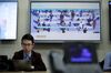 A television screen displays World Health Organization (WHO) information regarding COVID-19 during a news conference in Geneva, Switzerland.