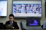 A television screen displays World Health Organization (WHO) information regarding COVID-19 during a news conference in Geneva, Switzerland.