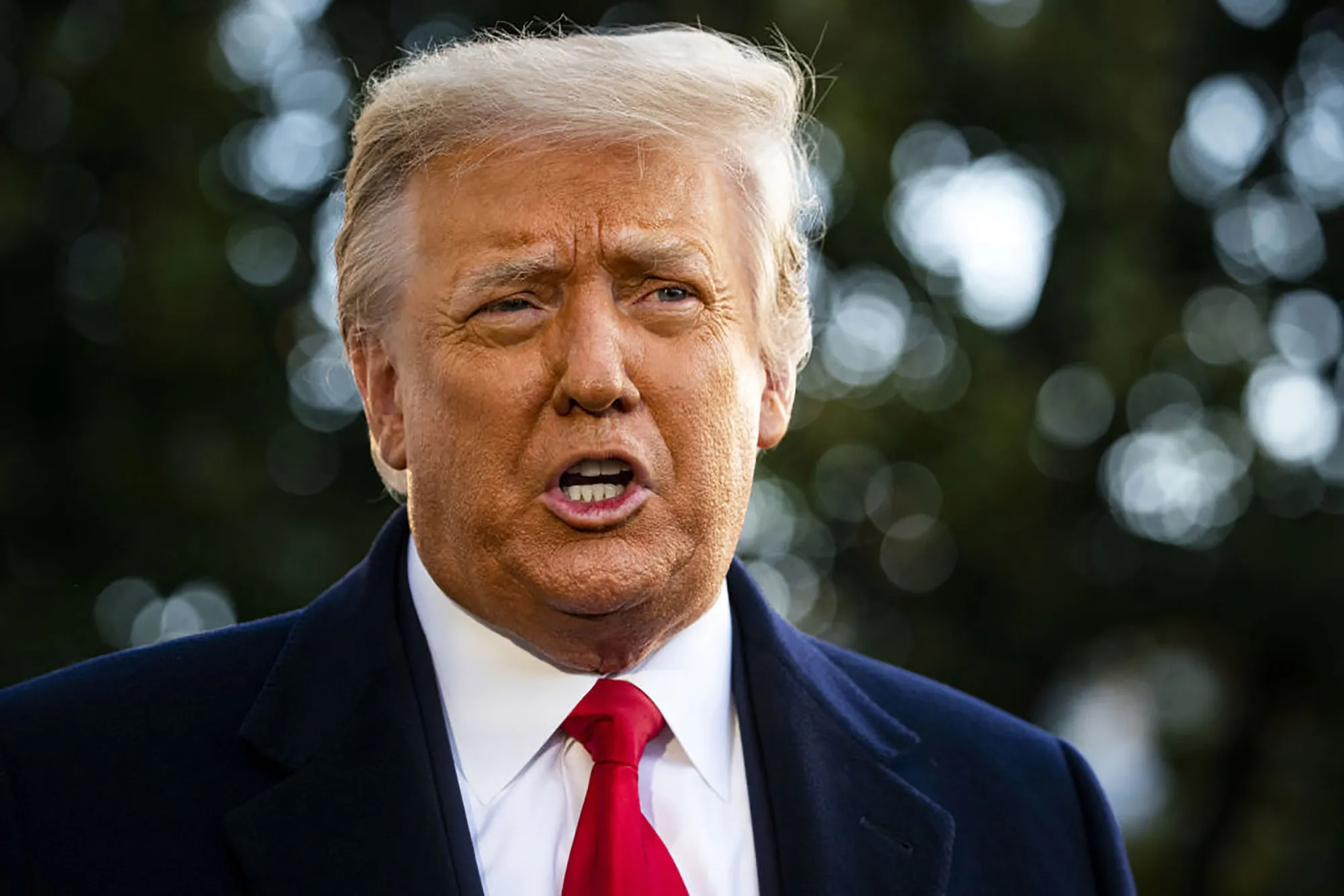 U.S. President Donald Trump speaks to members of the media before boarding Marine One on the South Lawn of the White House in Washington, D.C., U.S., on Wednesday, Jan. 20, 2021. Trump departs Washington with Americans more politically divided and more likely to be out of work than when he arrived, while awaiting trial for his second impeachment - an ignominious end to one of the most turbulent presidencies in American history.
