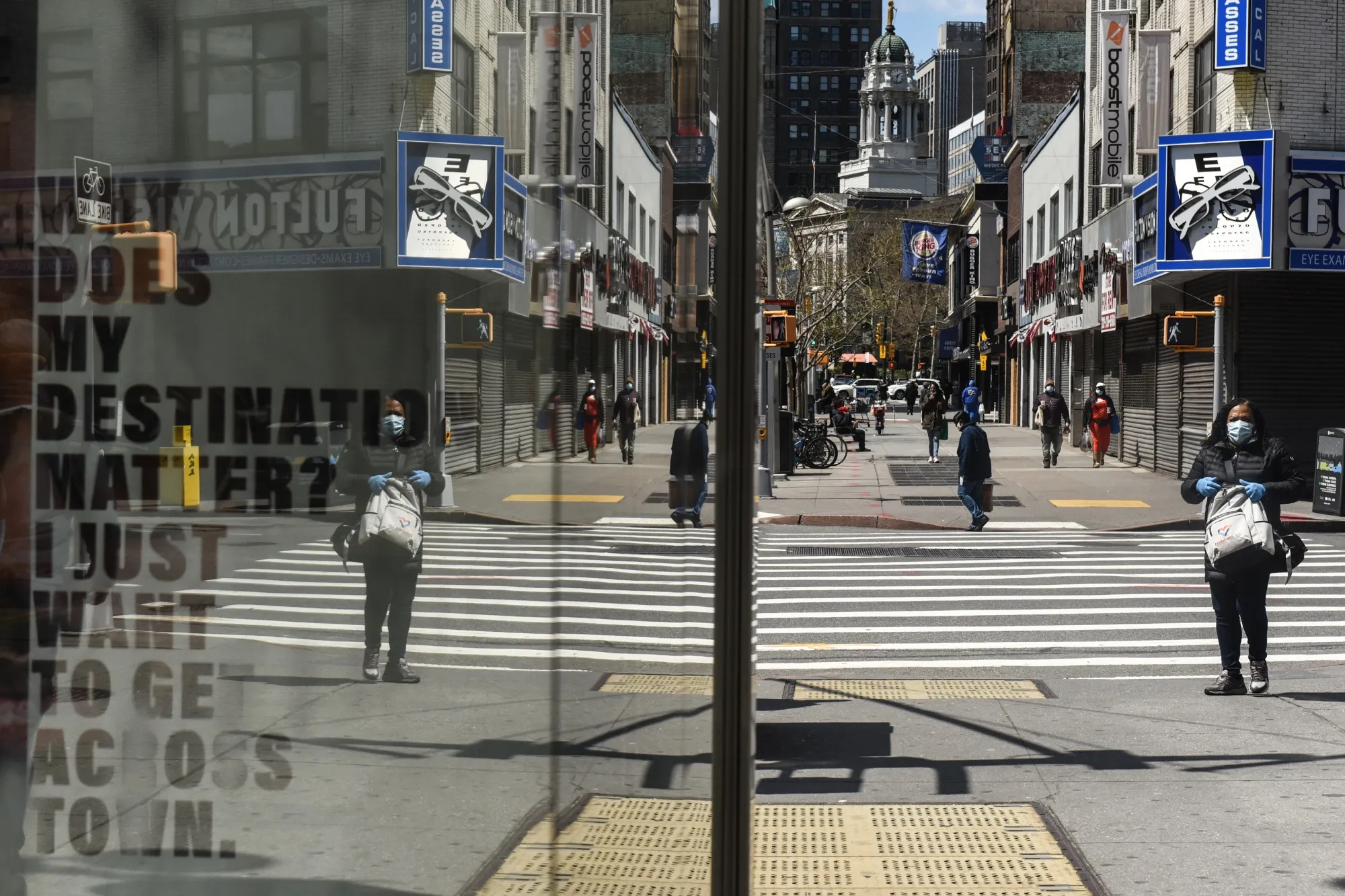 A pedestrian looks at a closed store in the Brooklyn Borough of New York, U.S., on April 15.