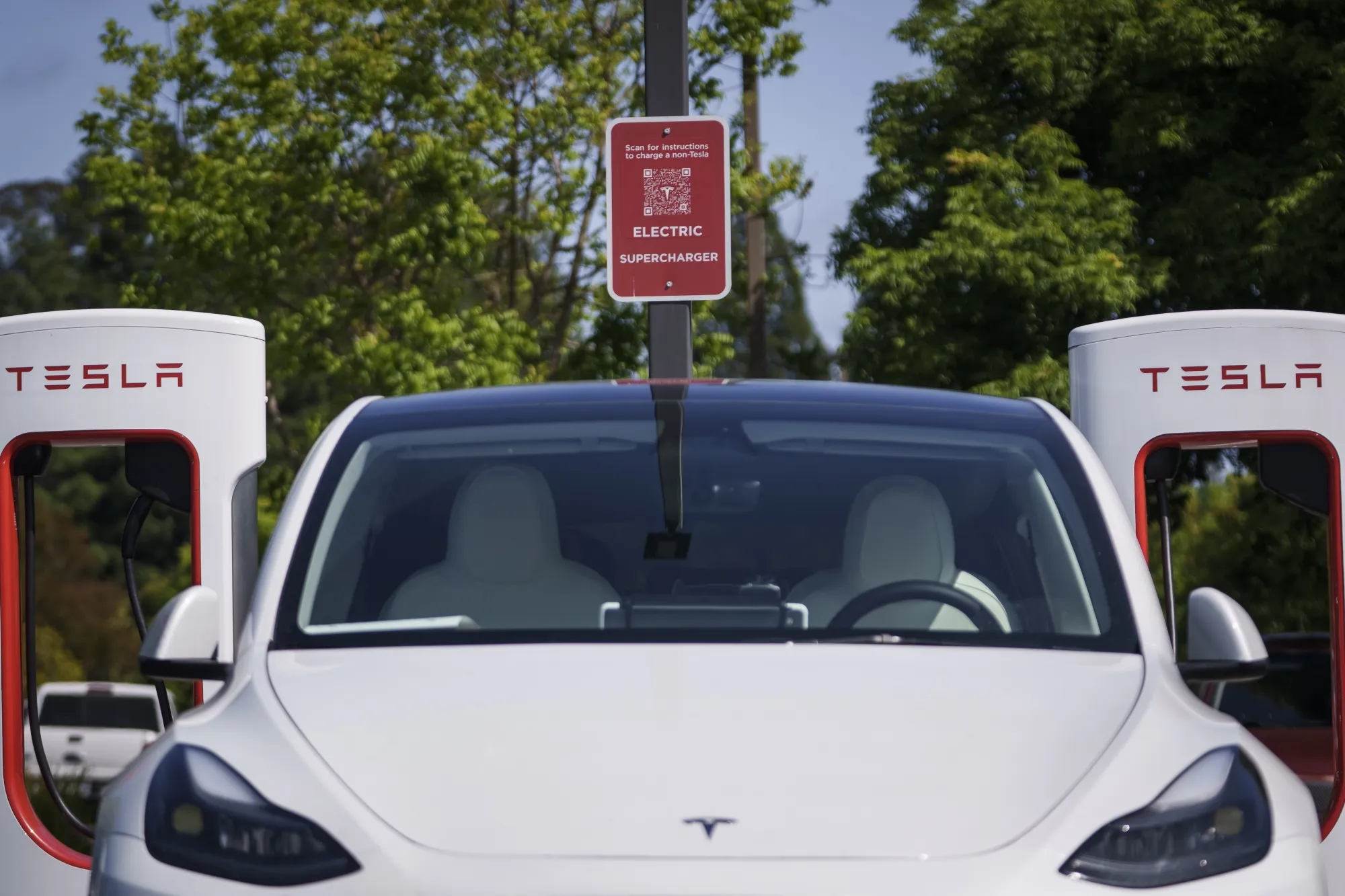 A Tesla Model 3 charging&nbsp;at a Supercharger in Scotts Valley, California.