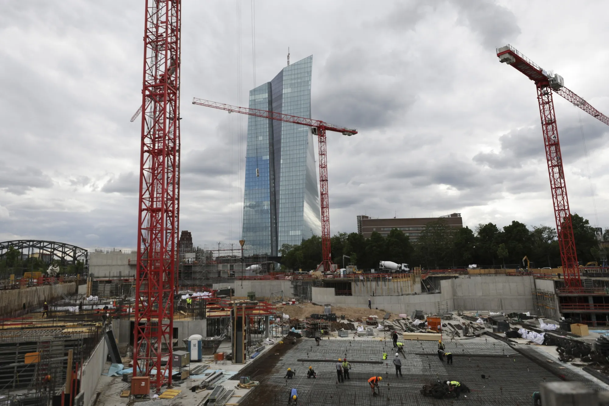 Construction workers labor on a building site near the European Central Bank headquarters in Frankfurt.
