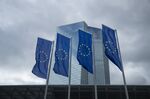 The stars of the European Union (EU) sit on banners flying outside the European Central Bank