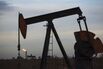 A pump jack stands at dusk in the Permian Basin area