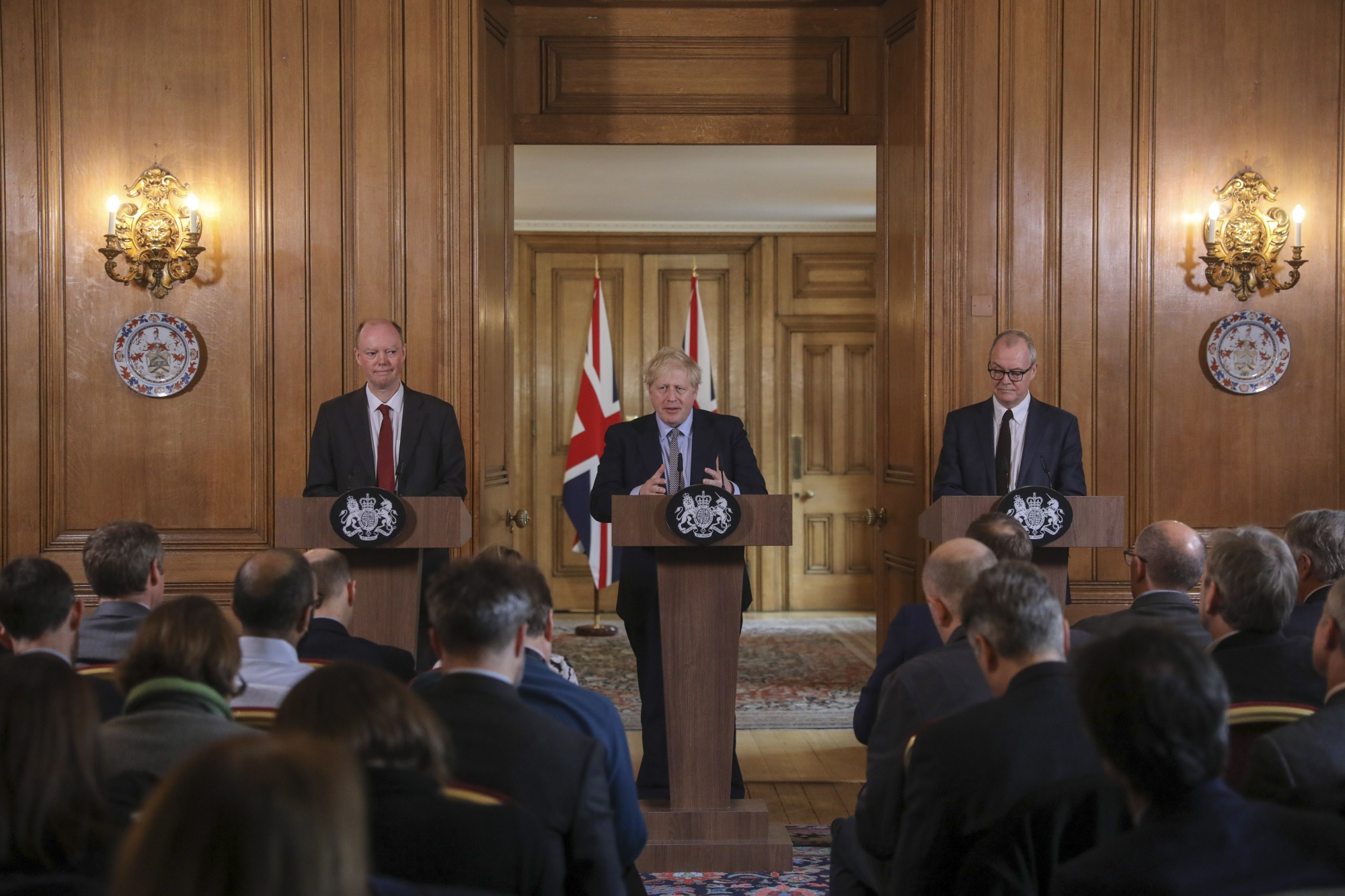 Boris Johnson, center, speaks alongside Chris Whitty, left, and Patrick Vallance, on March 3.