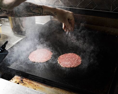 The classic burger involves two thin patties browned on the flat top, but the Salvation Burger is cooked over a wood-fired grill.