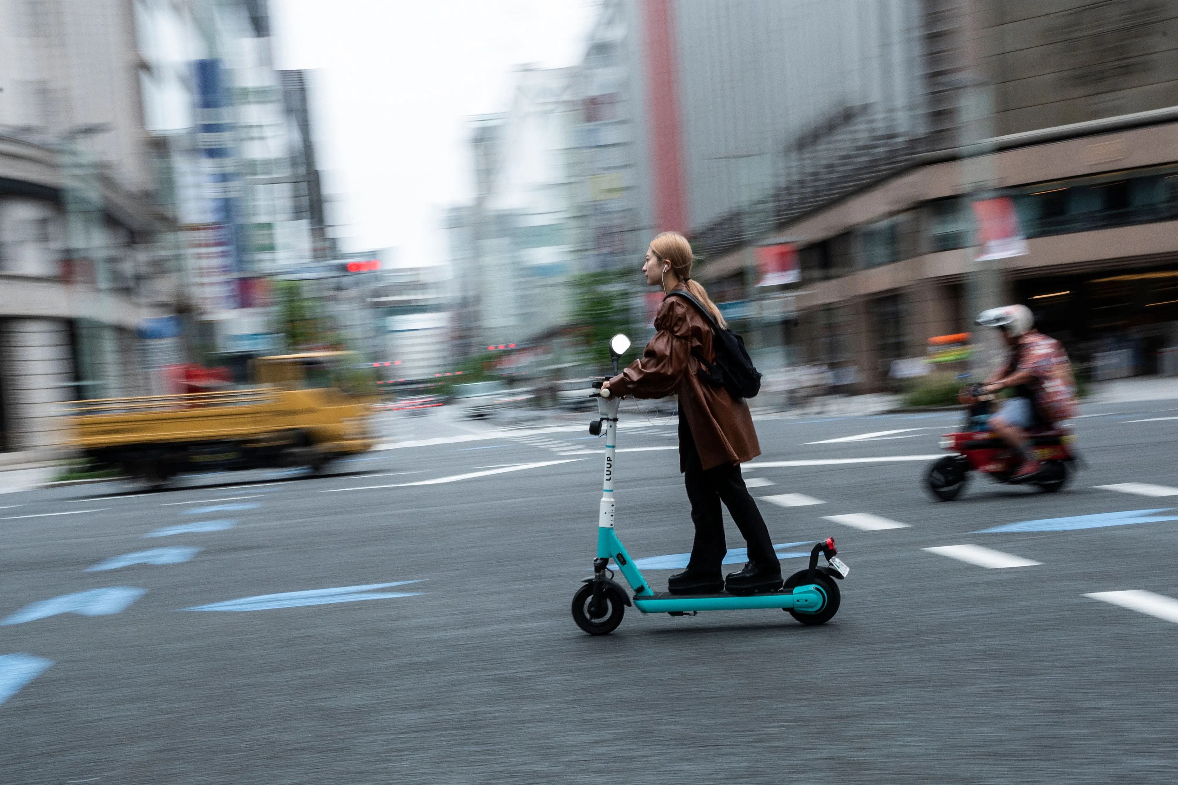 A woman rides a Luup e-scooter in Tokyo.
