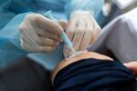 A nurse administers a Covid-19 booster vaccine. Photographer: Bloomberg Creative Photos/Bloomberg Creative Collection