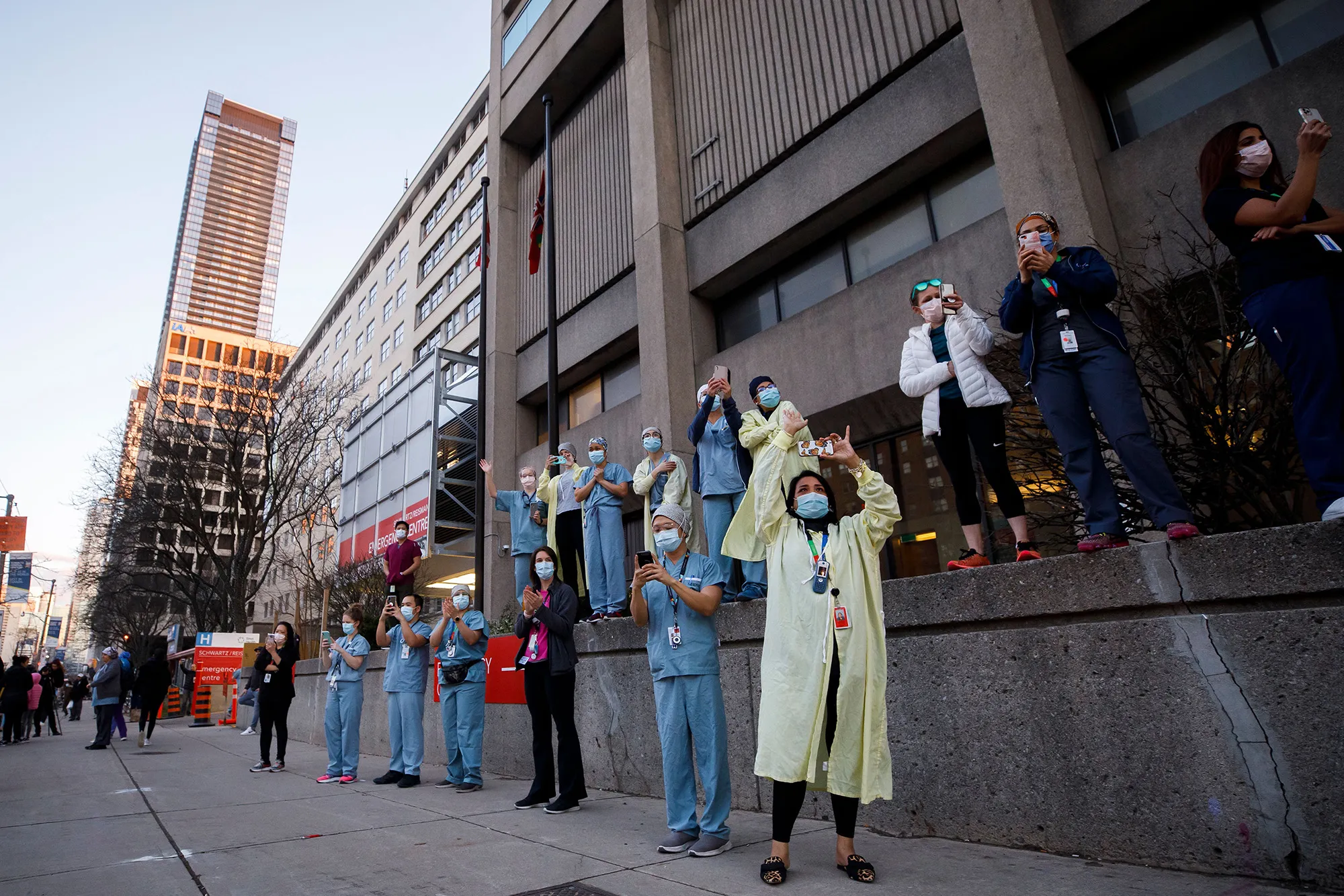 Healthcare workers applaud during a first responders parade in Toronto on April 19.