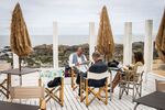 Customers read newspapers and magazines at a cafe on a sea-front esplanade in Porto, Portugal, on&nbsp;June 6.